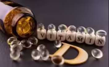 Vitamin D capsules spilled from a bottle with vitamin D lettering symbolizing vitamin deficiency and supplementation