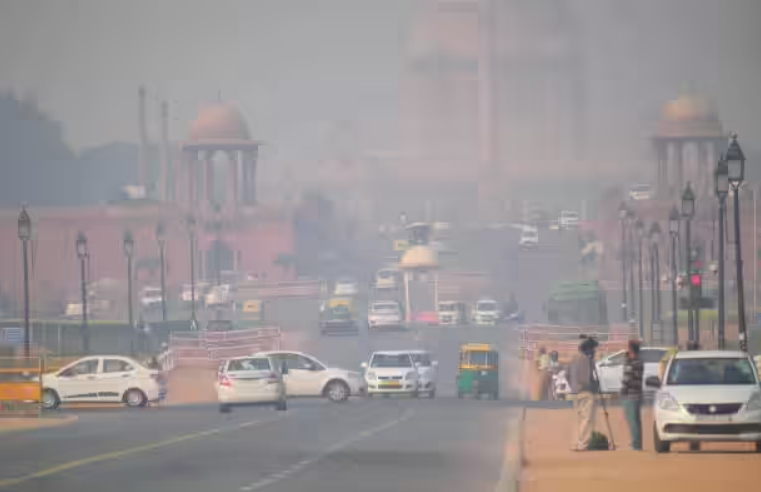 Smog-covered New Delhi street showing heavy traffic and reduced visibility due to air pollution