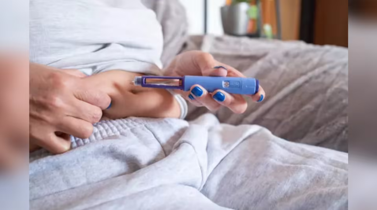 Person injecting diabetes medication with pen device highlighting GLP-1 treatment and blood sugar management