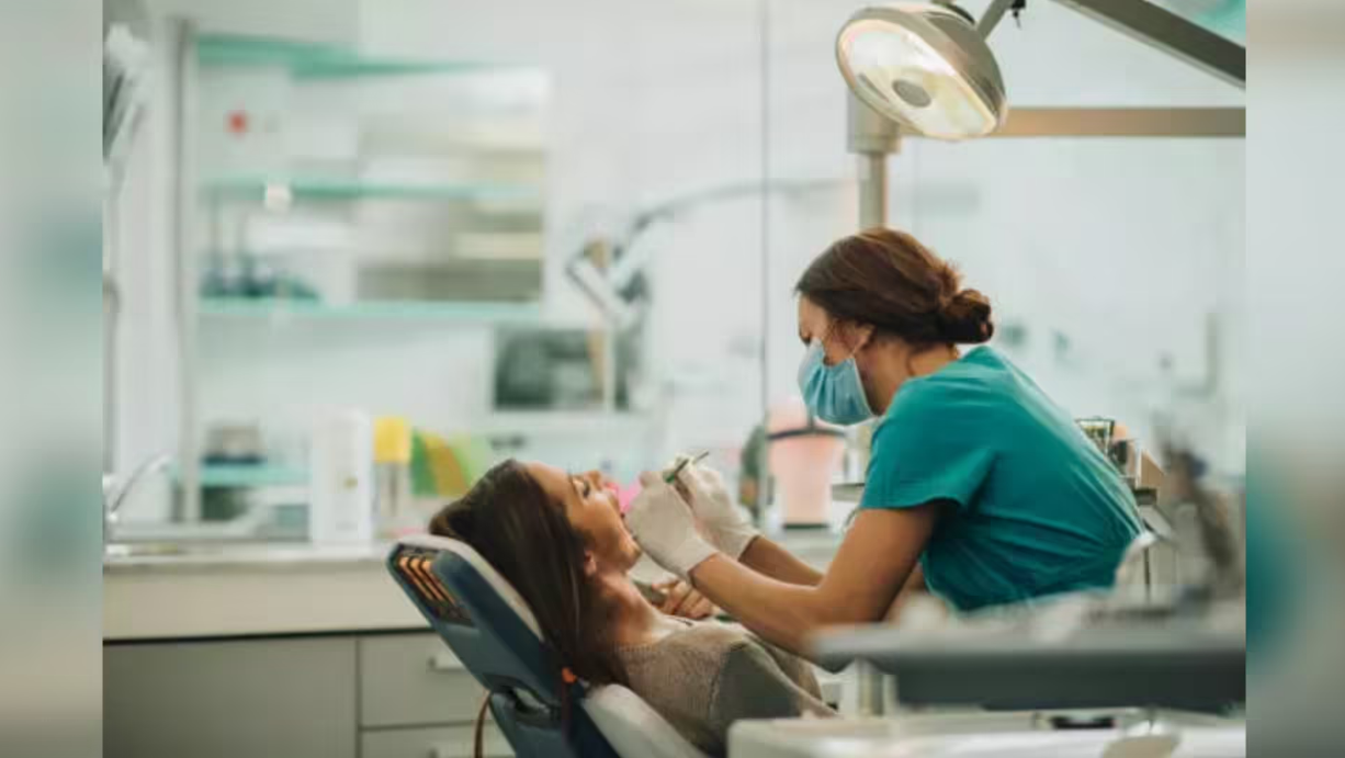 Dentist performing dental checkup on patient in clinic highlighting dental care services and oral health treatment