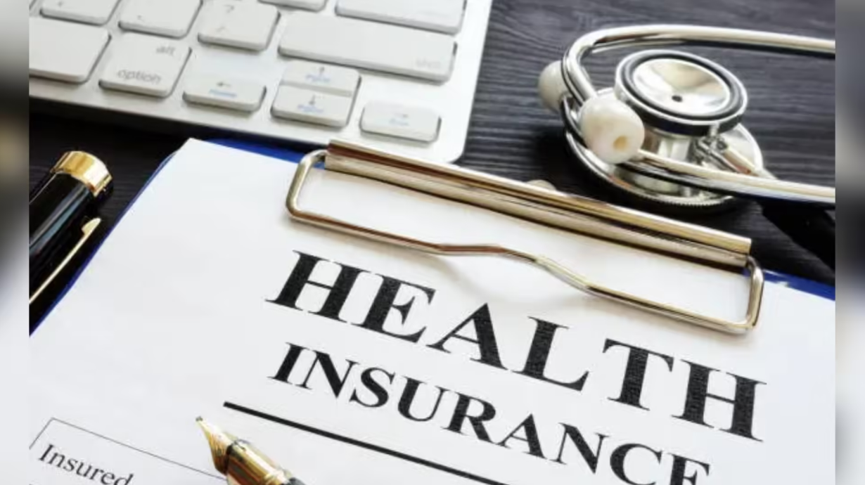 Health insurance document with stethoscope and keyboard representing medical insurance coverage and healthcare financing