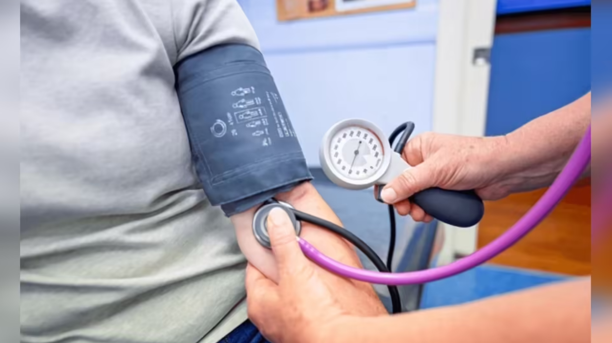 Doctor measuring blood pressure using sphygmomanometer during routine health checkup
