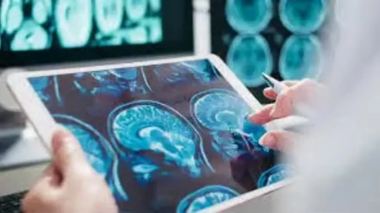 Doctor analyzing brain MRI scans on tablet for neurological disorders and Parkinson’s disease diagnosis