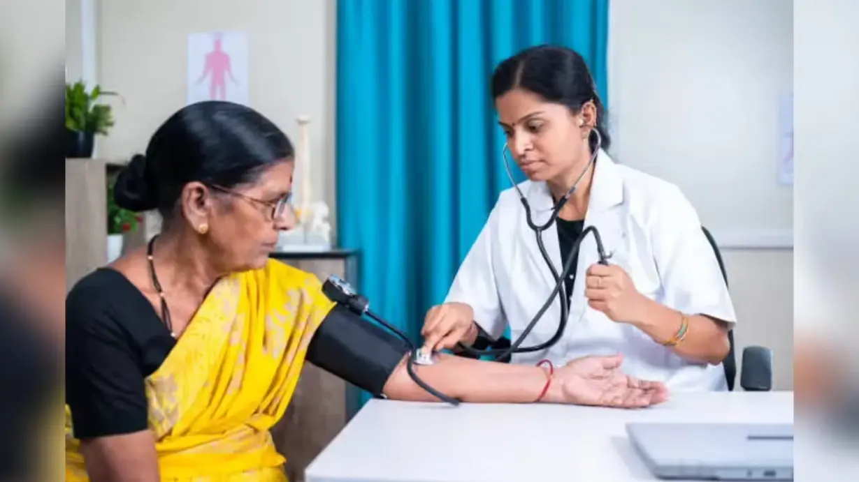Doctor checking blood pressure of elderly woman during routine health checkup in clinic