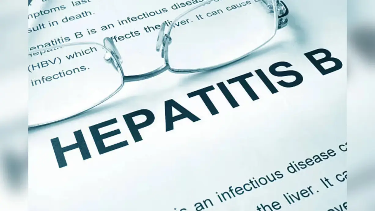 Hepatitis B medical document with eyeglasses highlighting liver infection and viral hepatitis health risk